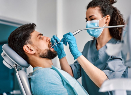 Oral surgeon examining a patient